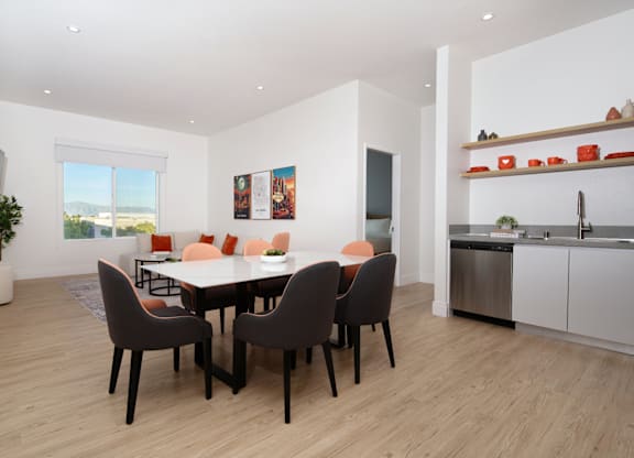 A modern dining room with a table set for six.