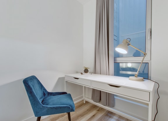 a workspace with a desk and a chair in a room