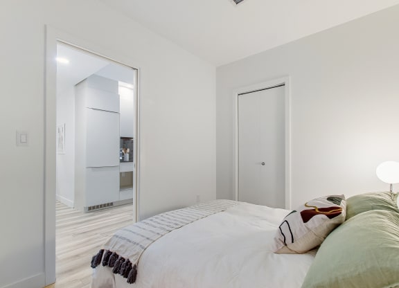 a bedroom with a bed and a mirror