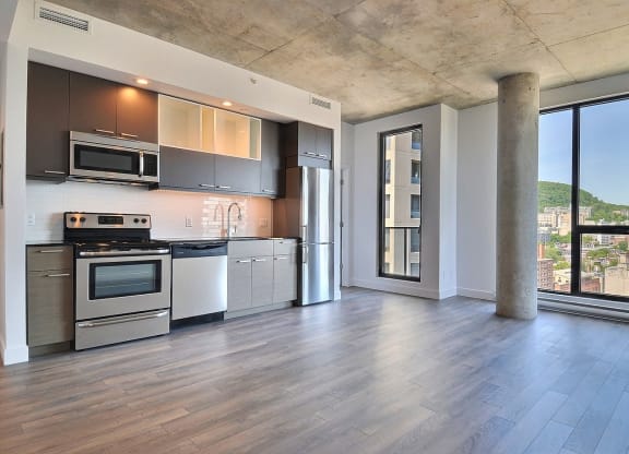 a kitchen with stainless steel appliances and a large window