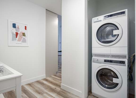 A white washing machine is in a laundry room.