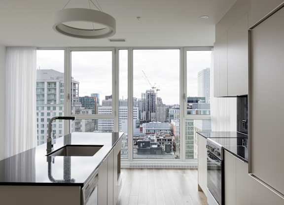A modern kitchen with a view of the city.