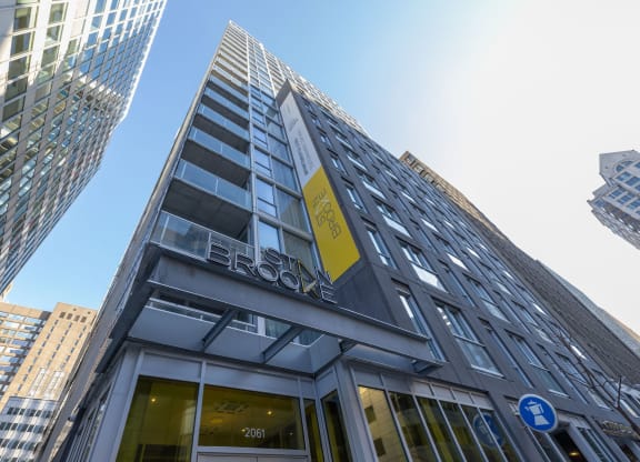 a tall building with a yellow sign on the side of it