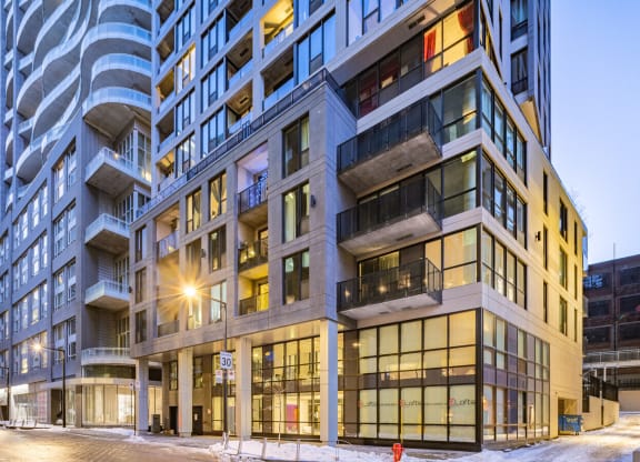a view of a building on a city street at dusk