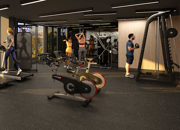 A group of people are working out in a gym with treadmills, weights, and exercise machines.