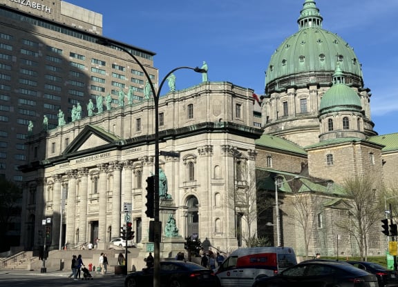 a large building with a green dome and a street light