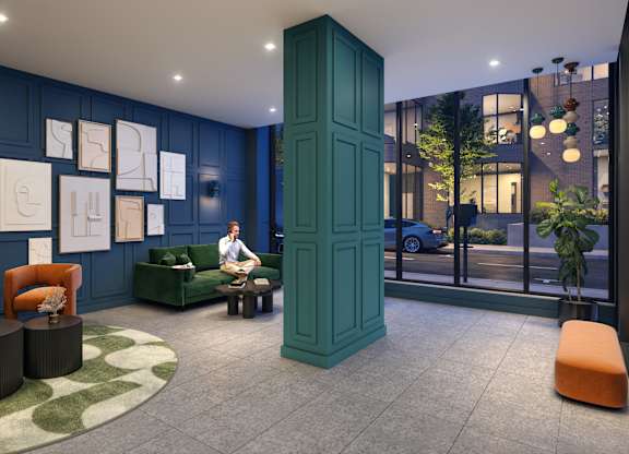 A room with a green cabinet and orange chairs.