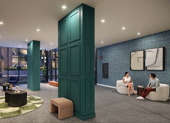 A woman is sitting on a couch in a room with green walls and a blue door.