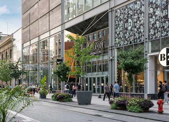 A street view of a shopping area with a B2 store.