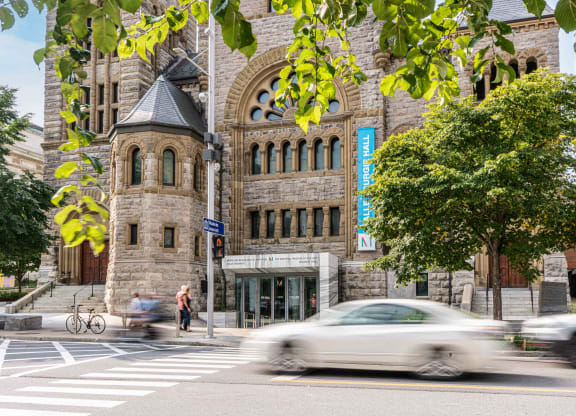a car driving down a street in front of a building