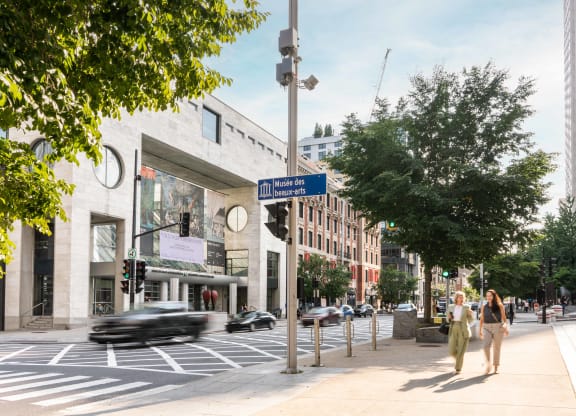 a rendering of a busy city street with pedestrians and cars