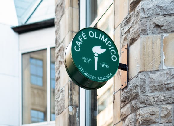 a green sign on the side of a brick building