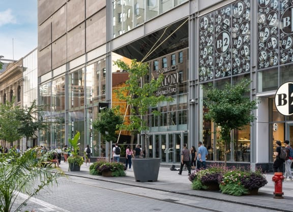 people walking in front of a glass building
