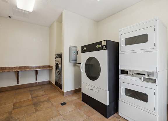 a kitchen with a washer and dryer and a laundry room with a sink
