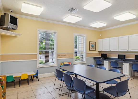 a classroom with a long table and chairs