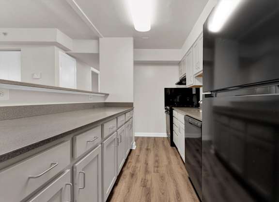 Kitchen With White Cabinetry And Black Appliances at Autumn Woods, Bladensburg, MD, 20710
