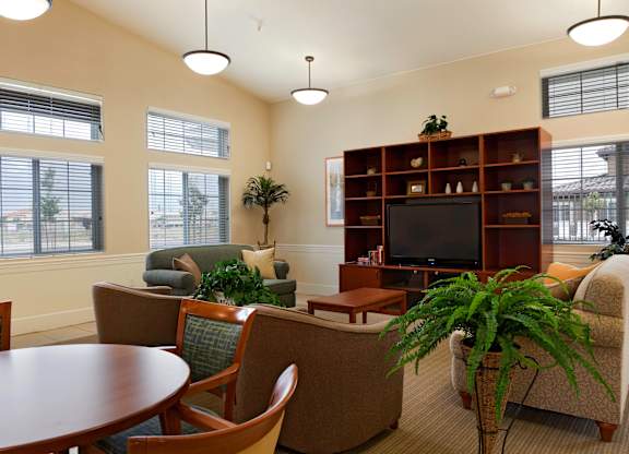 a living room with couches chairs and a table