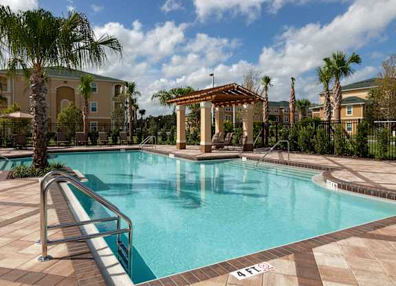 a swimming pool with a gazebo and palm trees