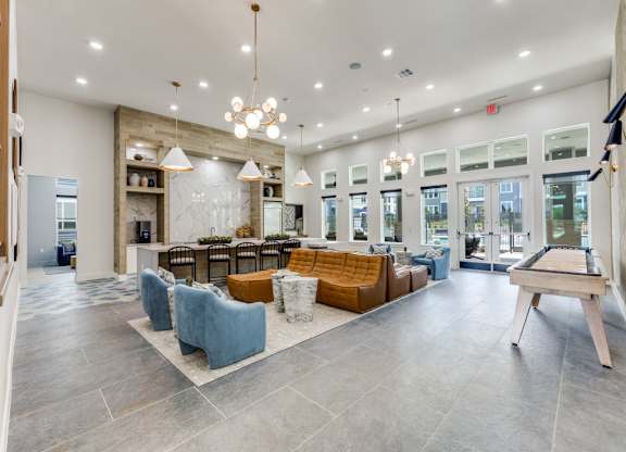 A spacious lobby with a pool table and comfortable seating.