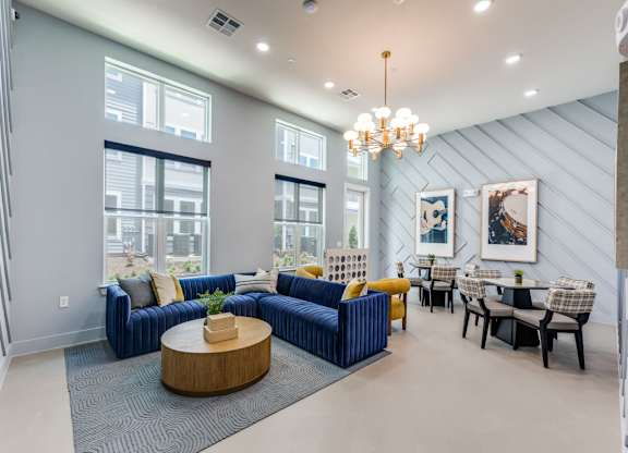 A modern living room with a blue couch and a wooden coffee table.