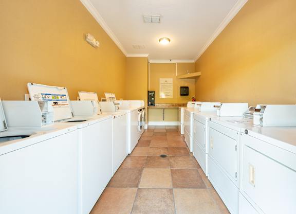 A kitchen with white appliances and counters.