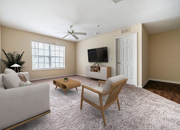 A living room with a couch, chair, and television.