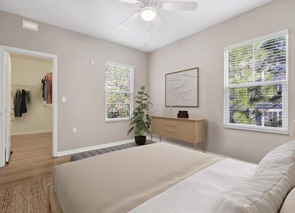 Bedroom with a ceiling fan and large closet at The Amalfi Clearwater Apartments