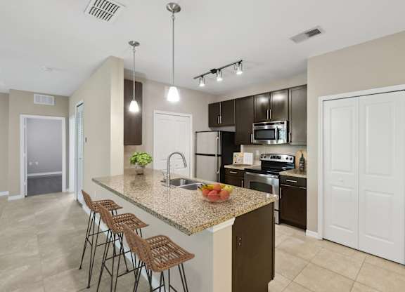 Open kitchen with upscale finishes at The Amalfi Clearwater Apartments
