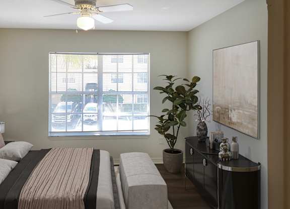 a bedroom with a bed and a window and a ceiling fan
