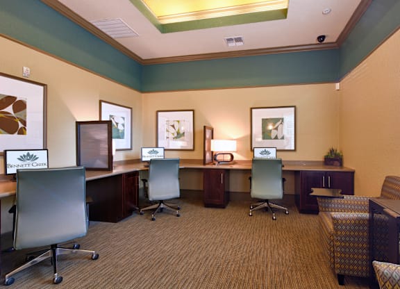 A room with a carpeted floor and a green chair.