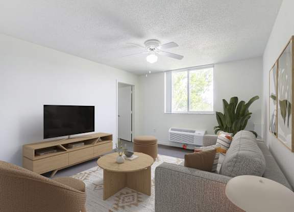 A living room with a television, a couch, and a coffee table.