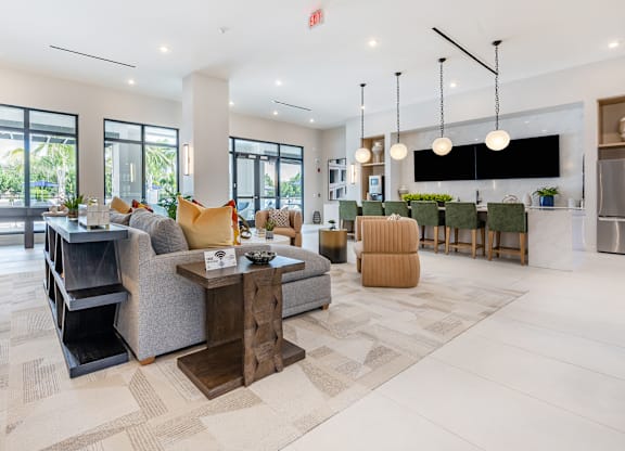 Clubhouse with Entertainment Kitchen and Lounge Seating at Marquee Square Apartments in Tampa, FLat Marquee Square Apartments in Tampa, FLat Marquee Square Apartments in Tampa, FL