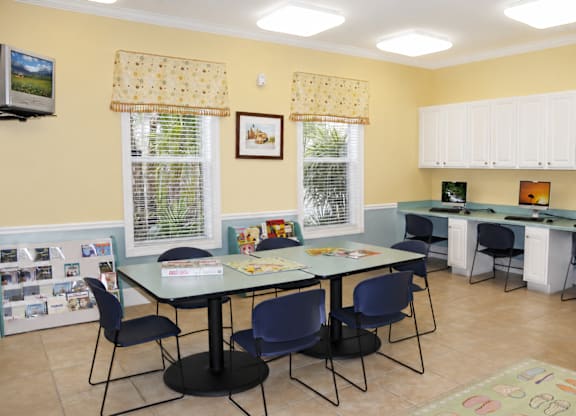 A dining room with a table and chairs.