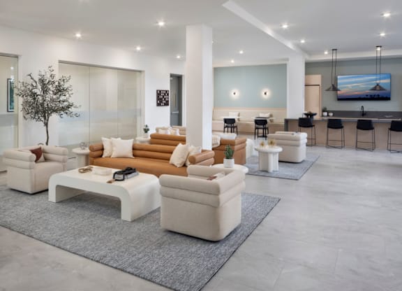 A modern living room with a white sofa set and a television.
