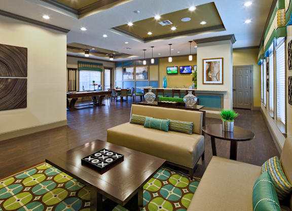 A living room with a couch, coffee table, and television.