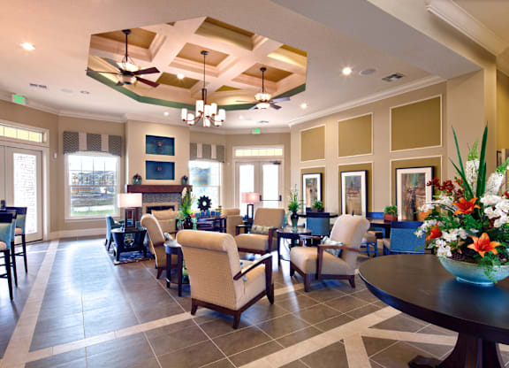 A large room with a table and chairs in it.