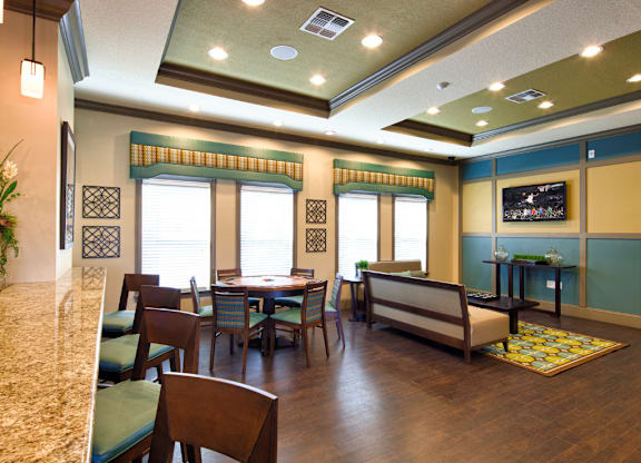 A dining room with a table set for six.