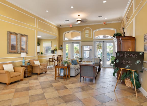 A living room with a chalkboard sign that says "Welcome Home".