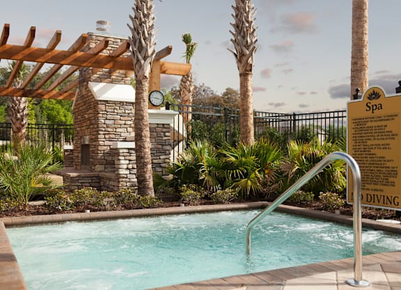 A pool with a diving board and a sign that says Spa.