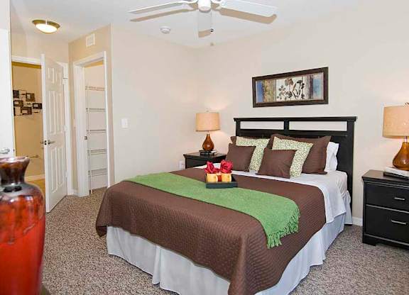 a bedroom with a bed and a ceiling fan