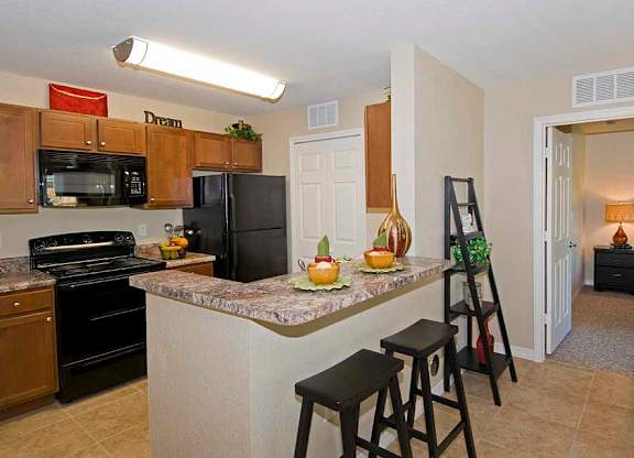 a kitchen with a counter top next to a stove top oven