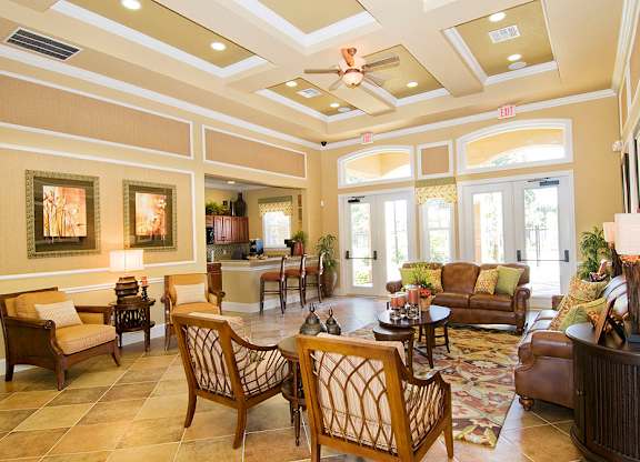 a resident clubhouse with couches chairs and a coffee table