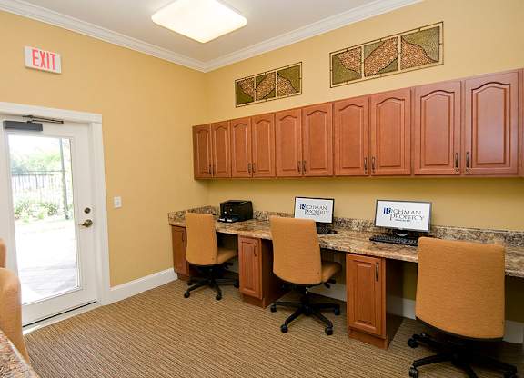 a break room with two computers and four chairs