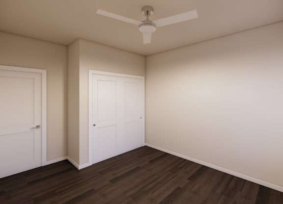 A room with a ceiling fan and two doors.