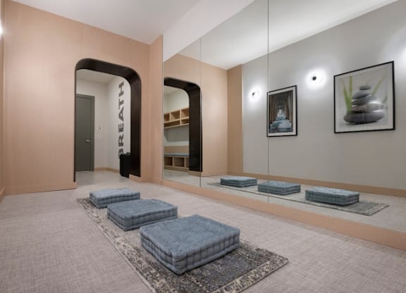 A spa room with a row of cushions and a mirror on the wall.