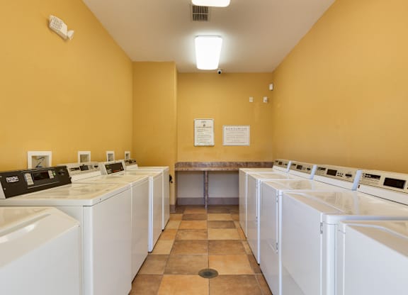 A laundromat with rows of washers and dryers.