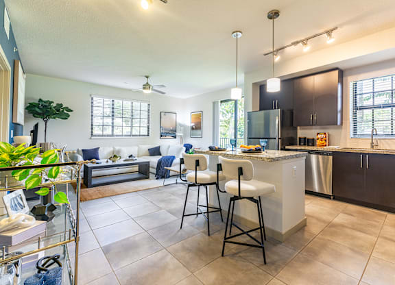 A kitchen with a white countertop and black cabinets.