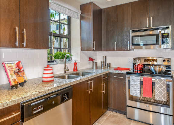 Modern kitchen with granite countertops at Palm Ranch Apartments in Davie, FL