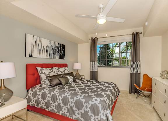 Bedroom with large window and a ceiling fan at Palm Ranch Apartments in Davie, FL