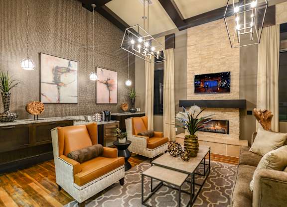 Sitting area with a fireplace in the clubhouse at Palm Ranch Apartments in Davie, FL